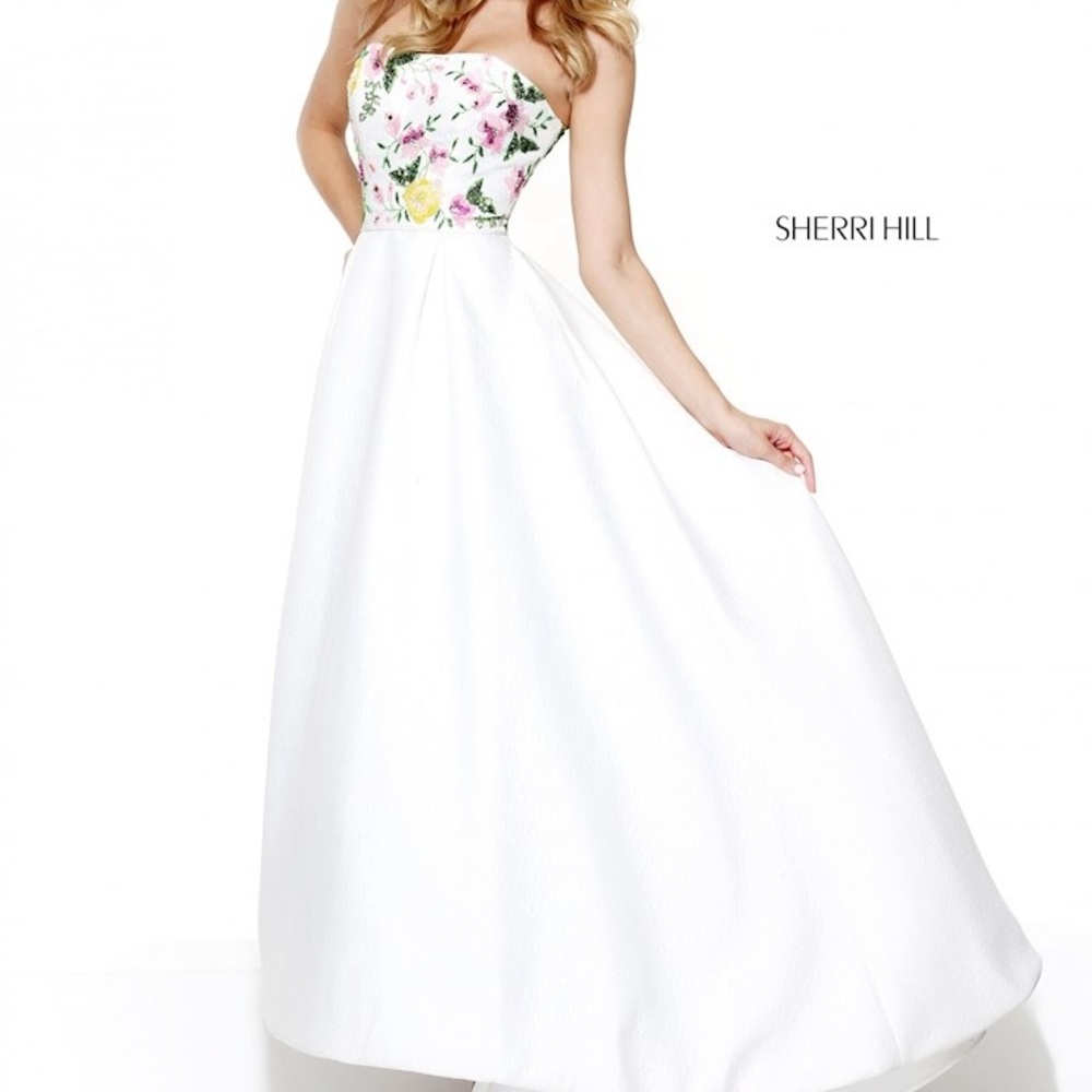 Sherri Hill. Beaded bodice, slight high/low hem. Beautiful white textured skirt.